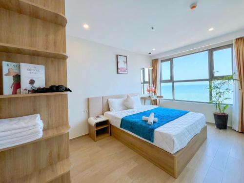 a bedroom with a bed and a large window at The Song Boutique Apartment in Vung Tau
