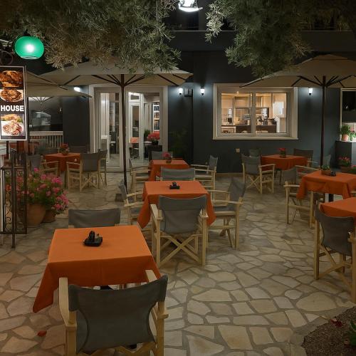 a restaurant with tables and chairs and umbrellas at Blue Lake Holiday Homes - Keri Summer Escape in Keri