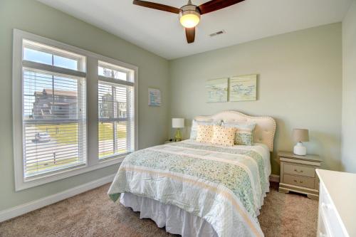 a bedroom with a bed and two windows at Sounds Beachy in North Topsail Beach