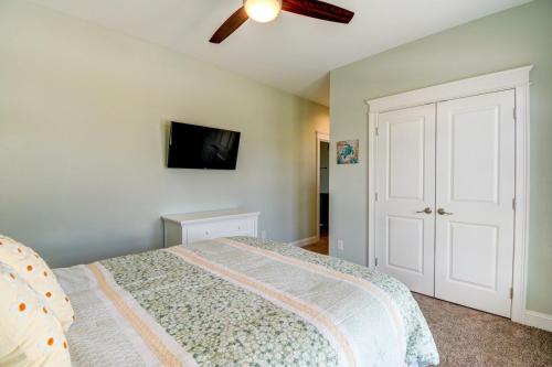 a bedroom with a bed and a ceiling fan at Sounds Beachy in North Topsail Beach