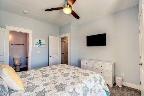 a bedroom with a bed and a flat screen tv at Sounds Beachy in North Topsail Beach