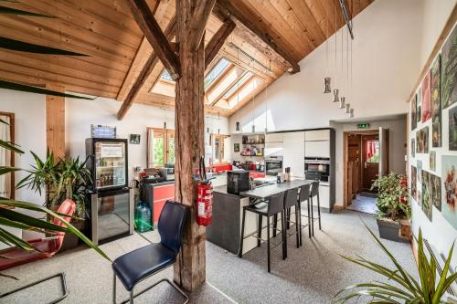 an open kitchen and living room with wooden ceilings at Chalet Elisthur in Saint-Jean-dʼAulps