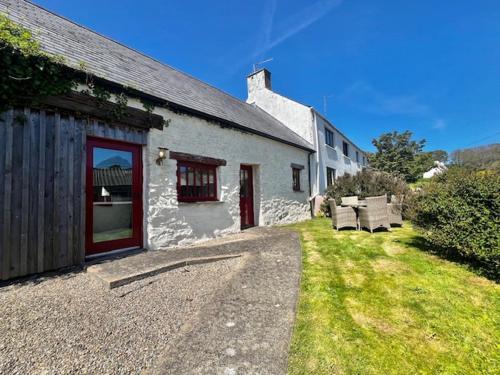 a white building with benches in front of it at Ysgubor in St. Davids