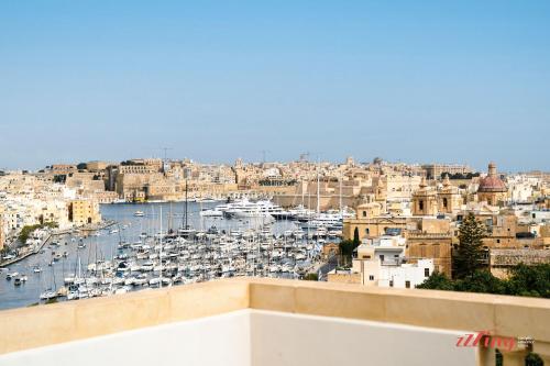 a view of a harbor with boats in the water at Yolanda Boutique Suites by Zzzing in Birgu