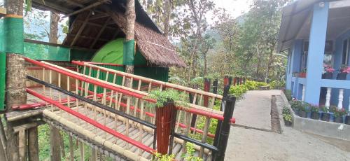 a fence in front of a building with plants at Angel Homestay in Darjeeling