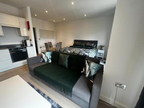 a living room with a couch and a bed at Grosvenor Rd Studio - Sleeps 4 Pet Friendly WiFi in St. Albans