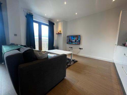 a living room with a couch and a table at Grosvenor Rd Studio - Sleeps 4 Pet Friendly WiFi in St. Albans