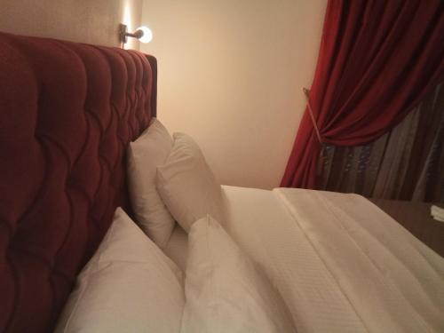 a bed with white sheets and pillows in a room at Delfini in Akhladherí
