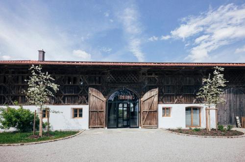 a large wooden barn with a large door at Das Frialing in Altenmarkt an der Alz