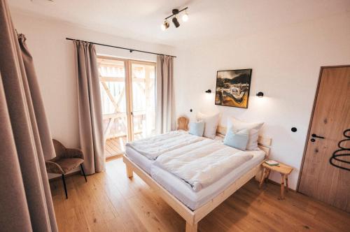 a bedroom with a large bed and a window at Das Frialing in Altenmarkt an der Alz