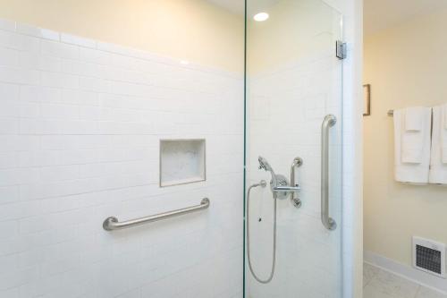 a shower with a glass door in a bathroom at First Floor Suites at The Legacy Inn Harmony Floor in Luray