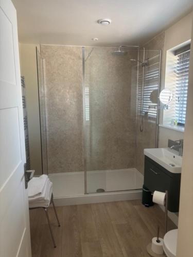 a bathroom with a shower and a sink at White Hart Inn in Brightling