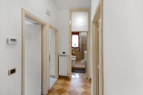 a hallway with white walls and a bathroom with a toilet at Zio Gennaro Residence in Agerola