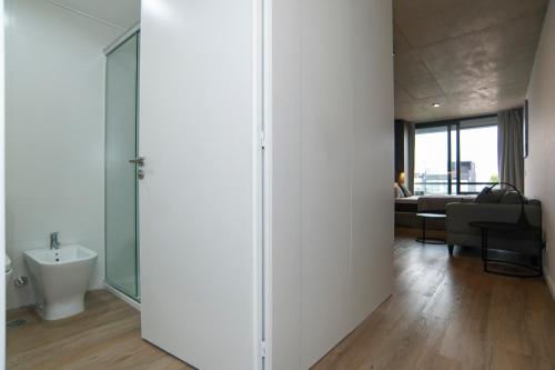 a room with a glass door leading to a living room at Babel Arcos in Buenos Aires