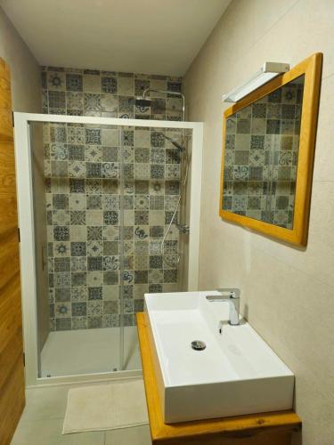 a bathroom with a white sink and a shower at Concha Aurea Apartments in Sveti Juraj