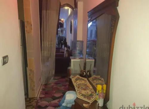 a hallway with a mirror and a table in a room at الاسكندريه ش العيسوى حى المنتزه in Alexandria