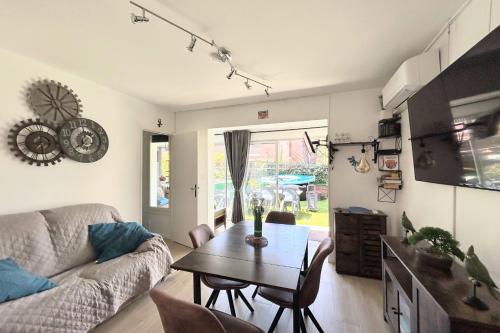 un salon avec une table et un canapé dans l'établissement EUREKA 58 - 4 People - Pool and Garden - Near Naturist Village and Beaches, au Cap d'Agde