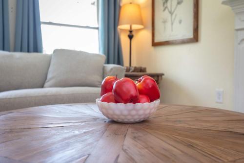 a bowl of red apples sitting on a table at The Legacy Suites Collection Full Property Rental in Luray
