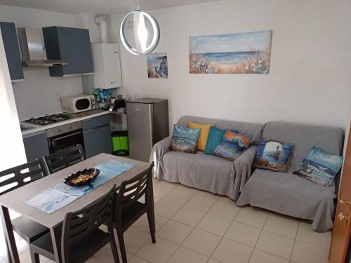 a living room with a couch and a table at Carmen House in Grottammare