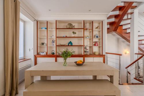 une salle à manger avec une table et un escalier dans l'établissement Maison de vacances en plein cœur des Sables Garage privé, à Les Sables-dʼOlonne