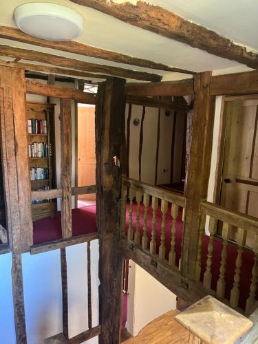 a room with wooden walls and a staircase with wooden beams at Chilton Manor House in Murston