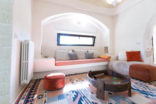 a living room with a bed and a window at Villa Bernardi in Ostuni