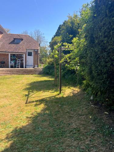 a yard with a fence in front of a house at Chilton Manor House in Murston