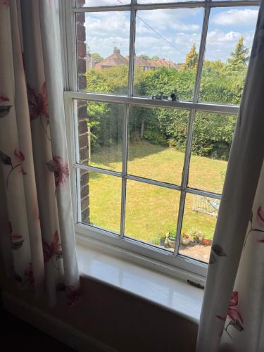 a window with a view of a yard at Chilton Manor House in Murston