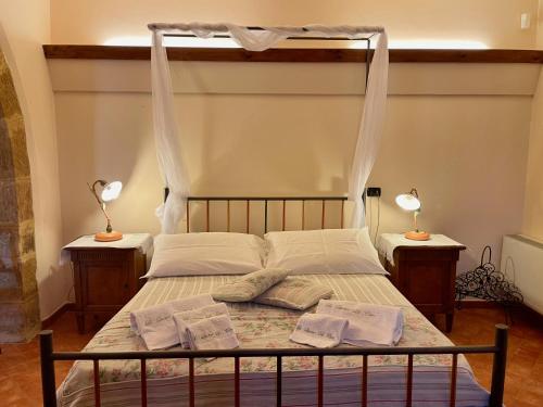 a bedroom with a canopy bed with two night stands at Le Querce di Cota in Troina