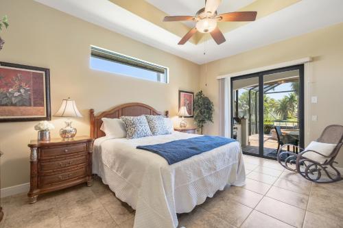 a bedroom with a bed and a ceiling fan at Villa Pearl in Cape Coral