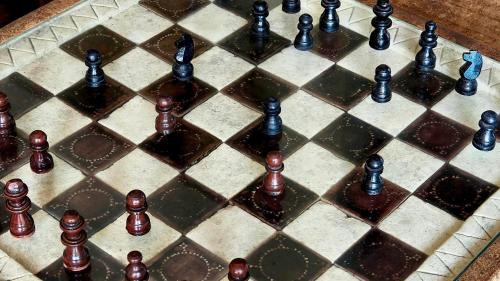 a close up of a chessboard with chess pieces at Gili Buana Hostel & Backpackers Gili Air in Gili Air