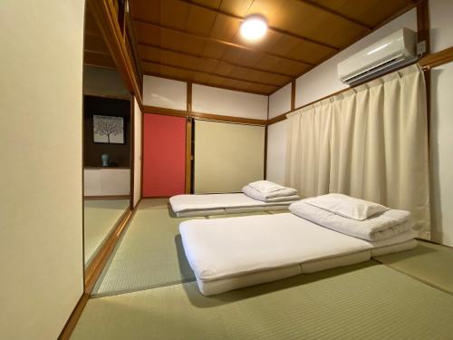 a room with two beds in it with at Naoshima Haru House in Naoshima