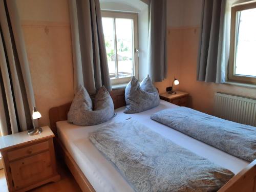 a bedroom with two beds with pillows on them at Asbichlerhof in Bad Endorf