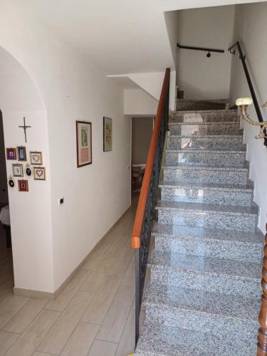 a staircase in a building with a cross on the wall at La Locanda Della Campanara in Santa Sofia