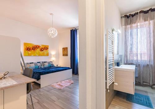 a bedroom with a bed and a sink in a room at Rooms and Rooftop Terrace Olbia Center in Olbia