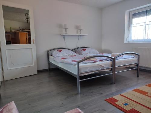 a bedroom with a bed in a room at Estike Apartmanok in Tiszafüred