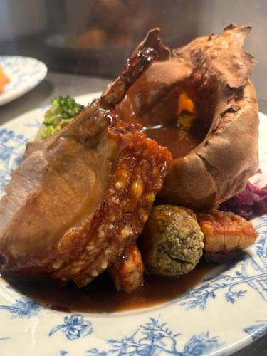 a plate of food with a piece of meat at The Ship Inn in Oundle