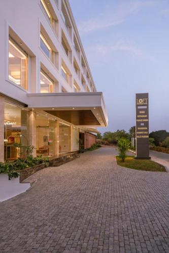 a building with a sign in front of it at Loft Business Hotel in Kakkanad