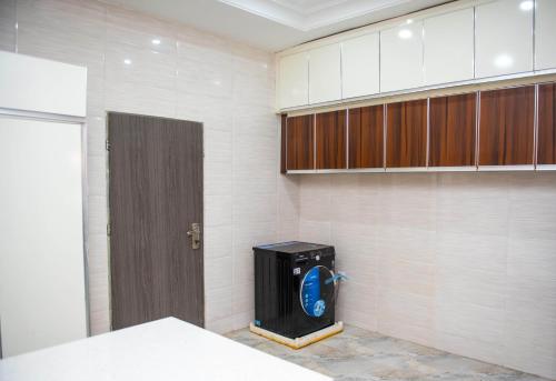 a room with a door and a room with aperature at BCL Homes and Apartments in Rubuchi