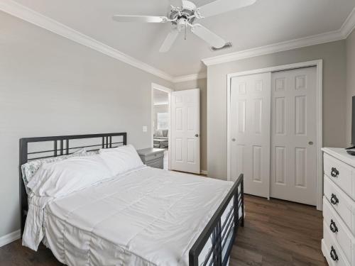 a white bedroom with a bed and a ceiling fan at 1315 Z2B VILLAGE OF RIO GRANDE by REMAX Premier in The Villages