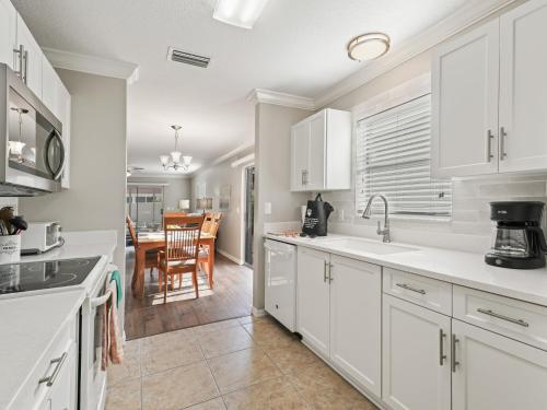 a kitchen with white cabinets and a dining room at 1315 Z2B VILLAGE OF RIO GRANDE by REMAX Premier in The Villages