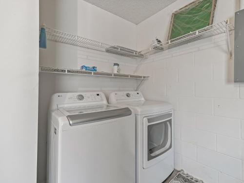 a washer and dryer in a white laundry room at 1315 Z2B VILLAGE OF RIO GRANDE by REMAX Premier in The Villages