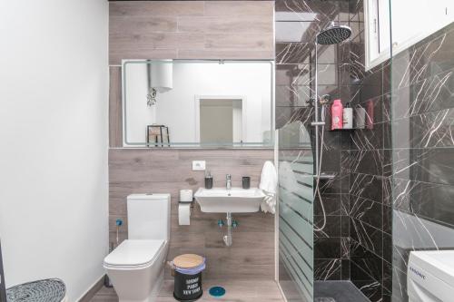 a bathroom with a sink and a toilet and a mirror at La Lajita in Tafira Baja
