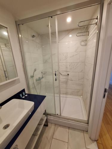 a bathroom with a shower and a sink at Orbi City rooms 1039 in Batumi