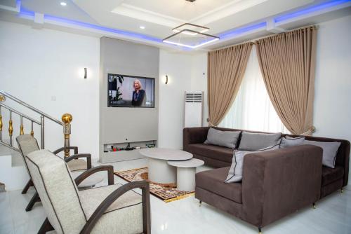 a living room with a couch and a table at BCL Homes and Apartments in Rubuchi
