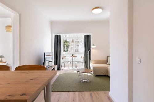 a living room with a couch and a table at Estoril One - New apartment in Estoril