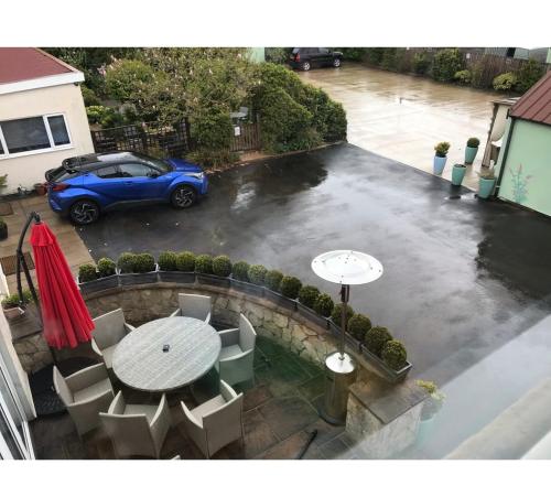 a blue car parked in a parking lot with a table at The Hawthornes Licensed Guest House in Knottingly