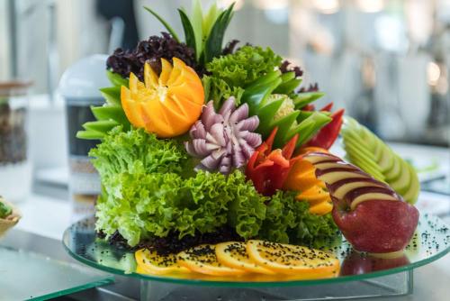 a plate of fruit and vegetables on a glass plate at Zante Park Resort & Spa BW Premier Collection in Laganas