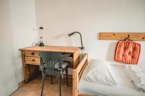 a bedroom with a desk and a bed and a bed and a lamp at Fewo - Haffliebe in Ueckermünde