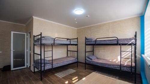 a room with three bunk beds in it at 4ua-хостел in Bratslav